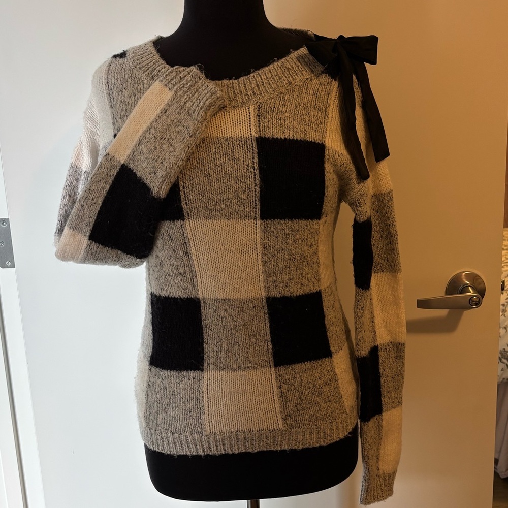 RW&CO. Black/white/gray Checkered Sweater with bow tie on shoulder.